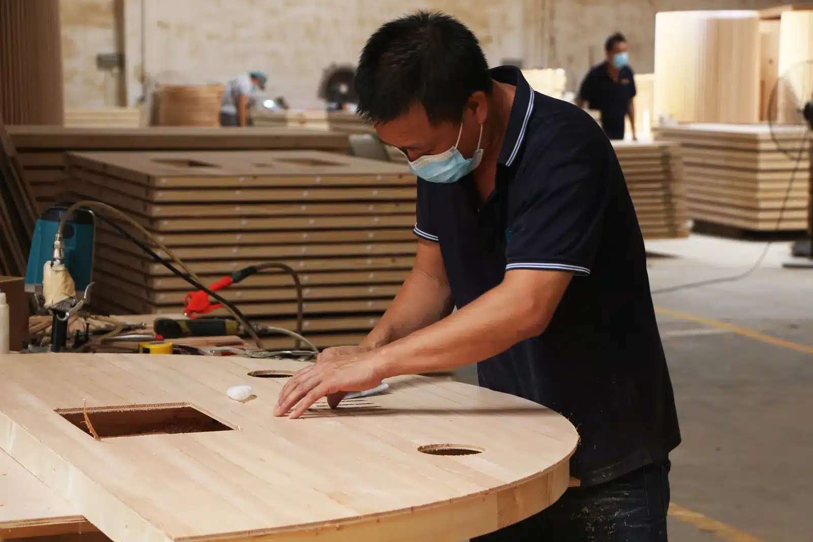Bropool workshop worker assembling a curved wooden component