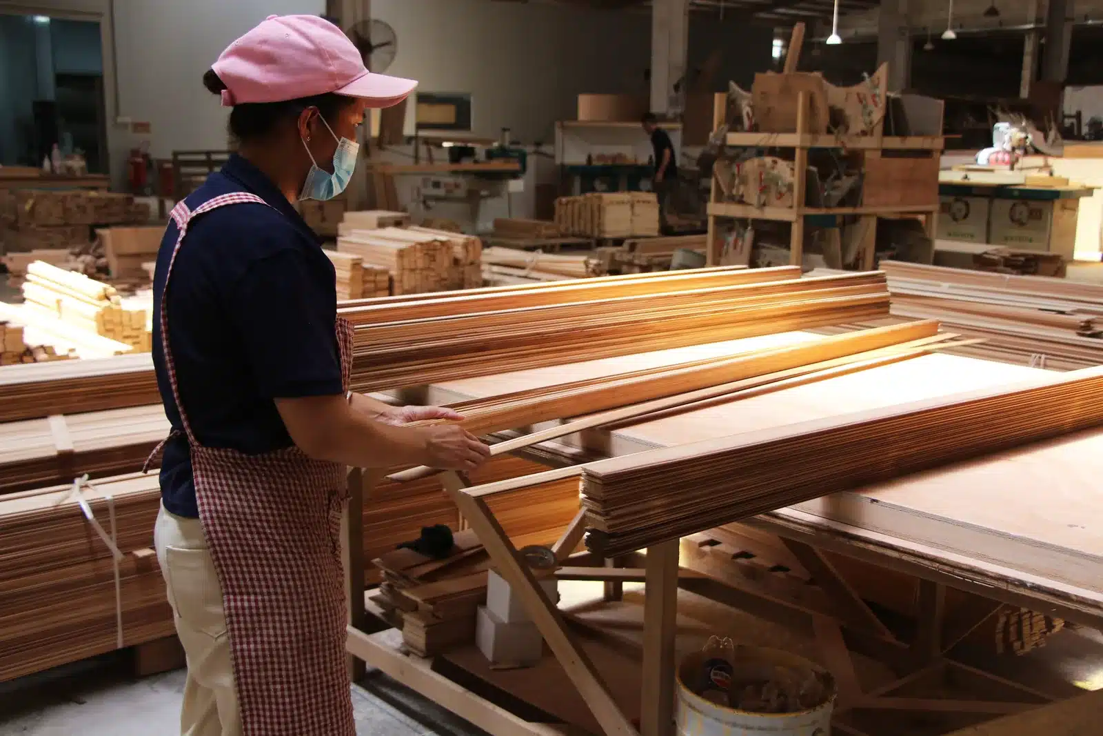 Bropool workshop employee inspecting prepared timber slats for sauna production