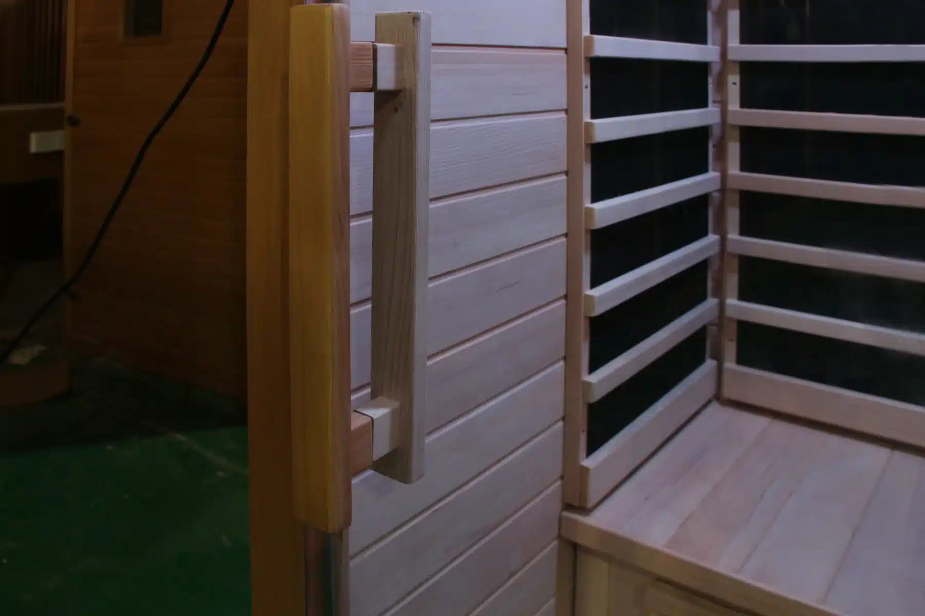 Bropool IS-1101 infrared sauna interior with guarded heating panels and wood bench