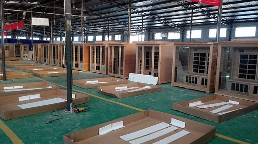 Sauna cabins and protective packaging on the workshop floor